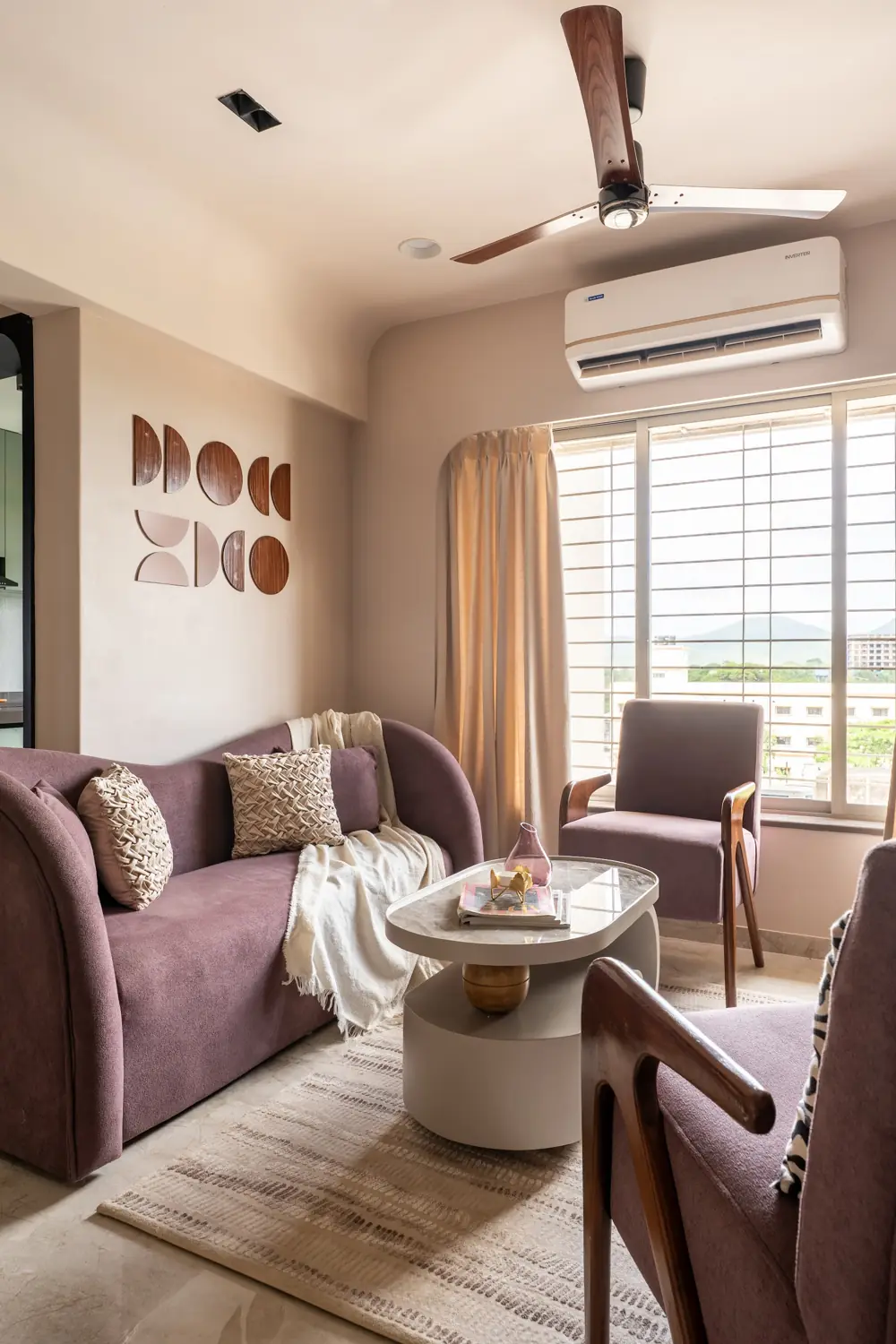 Mauve sofa and armchair by the window