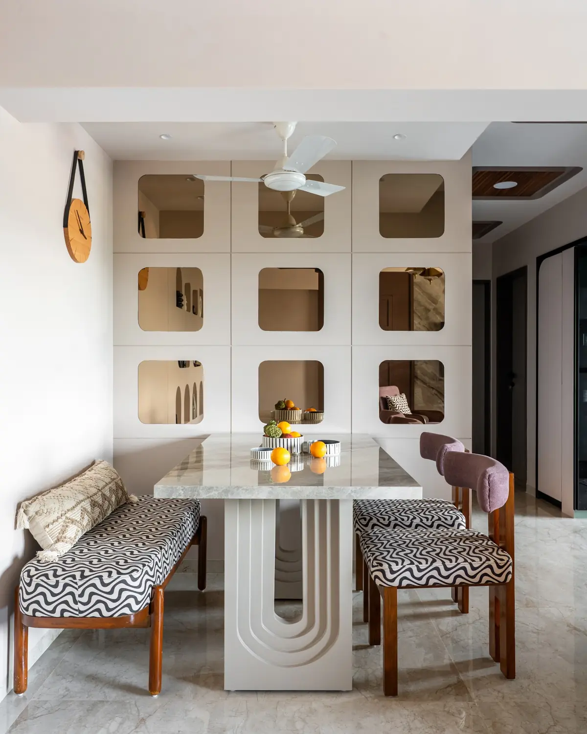 Dining nook with a sculpted mirror cabinet