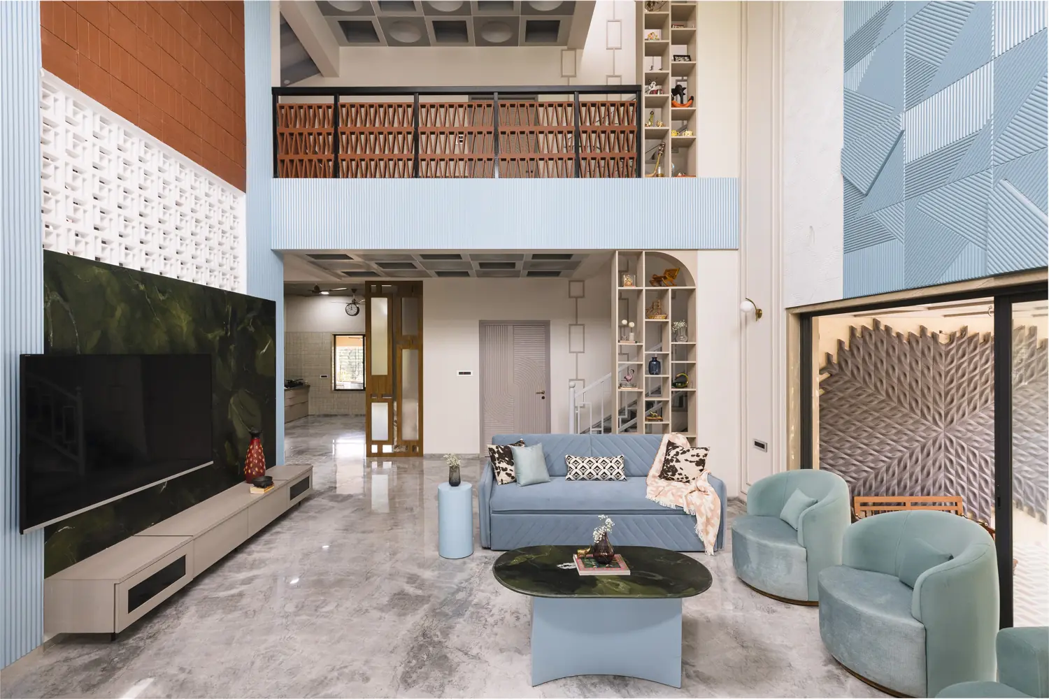 Living room seen from the entrance, with a lattice gallery above and a green marble TV wall