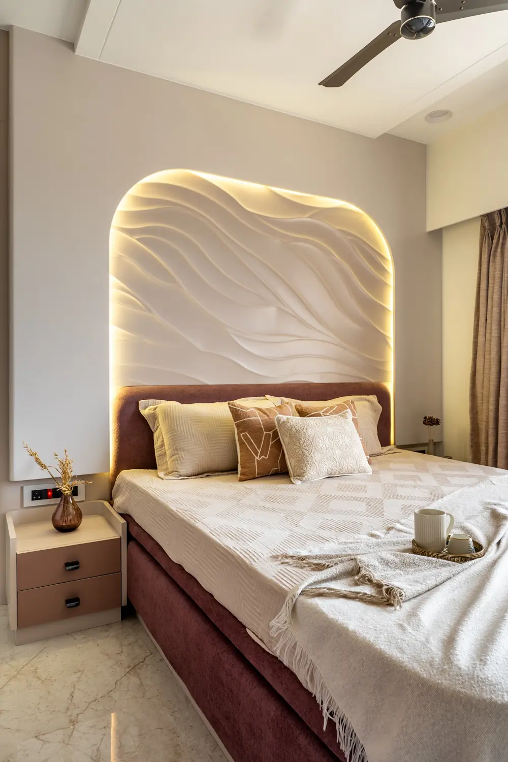 Casa Umber bedroom with a carved wave wall behind the bed