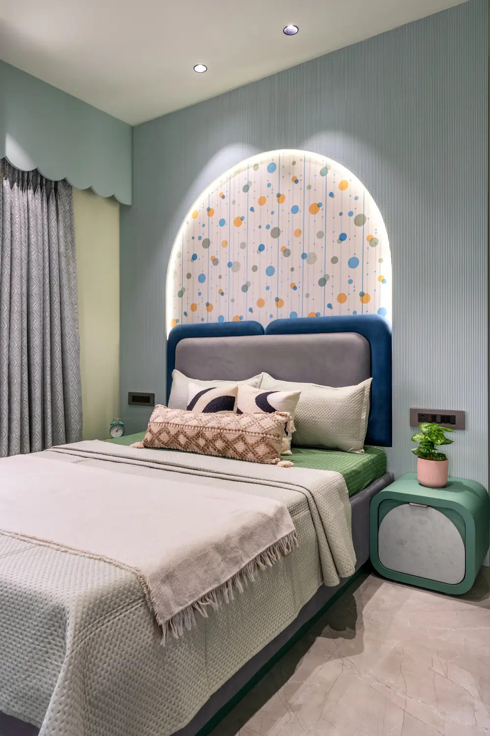 Sage-green kids room with a terrazzo arch headboard