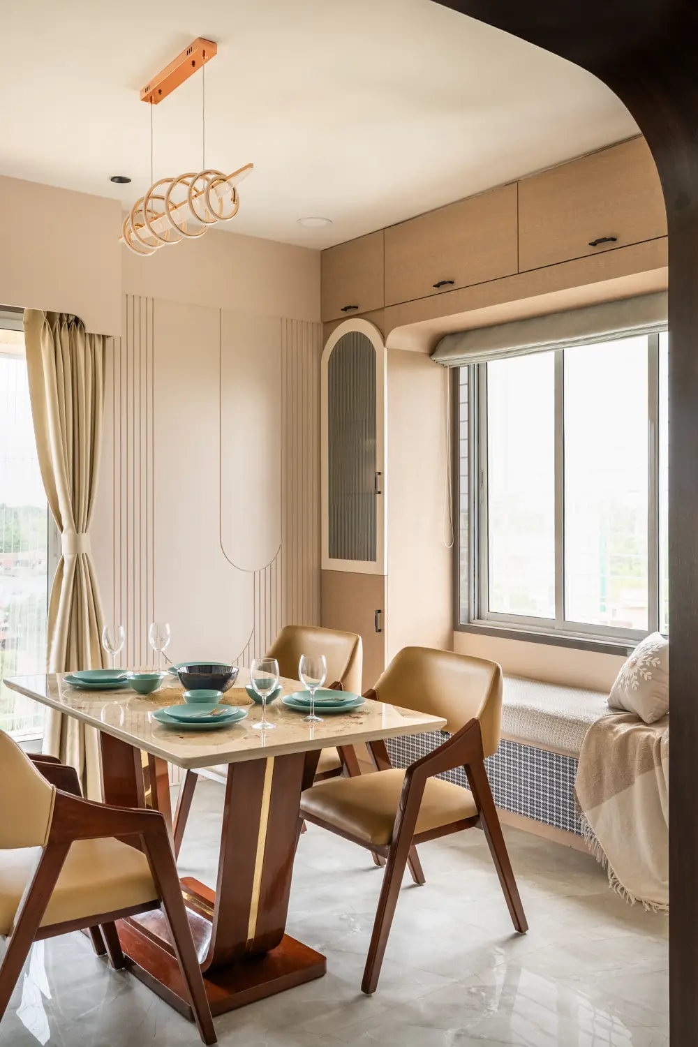 Round dining table under a brass pendant